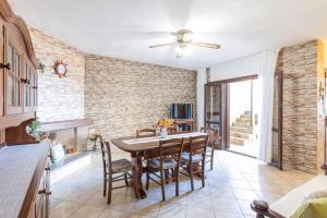 a dining room with a table and chairs at Costa Verde - Panoramic Stay Terrace Wifi BBQ AC in Torre Dei Corsari
