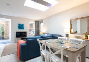 a living room with a blue couch and a table at 2 Bedroom Apartment in North Berwick in North Berwick