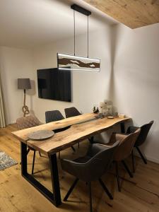 a dining room with a wooden table and chairs at Apartmán Máj 104 in Pec pod Sněžkou