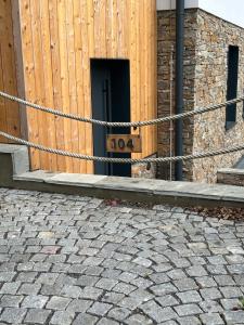 a door with a sign in front of a building at Apartmán Máj 104 in Pec pod Sněžkou