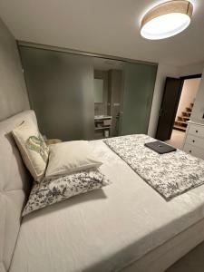 a bedroom with a bed with a laptop on it at Apartmán Máj 104 in Pec pod Sněžkou