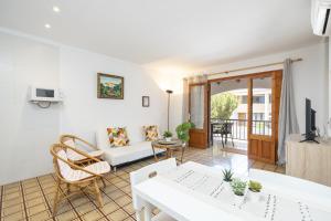 a living room with a couch and a table at Apartamentos MHM in Cala Ratjada