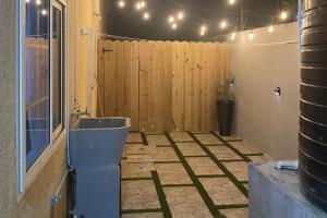 a room with a wooden fence and a toilet at Beautiful 3-Bed House in Saint Catherine Portmore in Central Village +40 photos