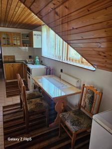 a kitchen with a table and chairs in a kitchen at Privát Marika in Terchová +14 photos