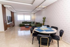a living room with a table and a couch at Casa Streets 3 BR Terrace - AppartAli Luxury Platform in Casablanca
