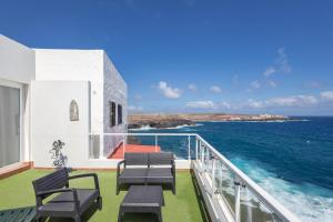 a balcony with chairs and a view of the ocean at PentHouse Loft - Terrace & Natural Pool in Gáldar