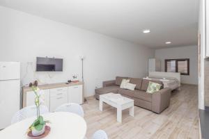 a living room with a couch and a table at PentHouse Loft - Terrace & Natural Pool in Gáldar