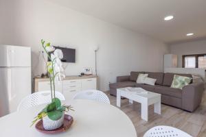 a living room with a white table and a couch at PentHouse Loft - Terrace & Natural Pool in Gáldar
