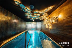 a swimming pool in a room with a chandelier at Radisson Blu Carlton Hotel, Bratislava in Bratislava