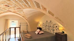 Ένα ή περισσότερα κρεβάτια σε δωμάτιο στο Residence La Corte delle More