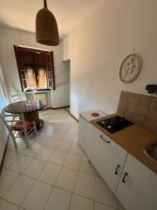 a kitchen with a table and a sink and a table at Residence Villa Eva in Marina di Massa