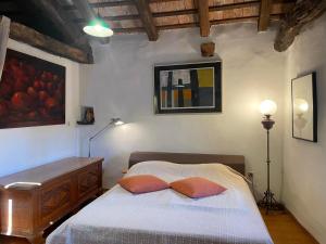 a bedroom with a bed with two pillows on it at Karst house Mediteranean Slovenia in Dutovlje