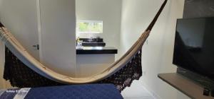 Μια τηλεόραση ή/και κέντρο ψυχαγωγίας στο Apartamento Completo Barra Grande S8