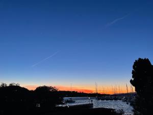 a group of boats in a river at sunset at HOTEL JARDINS DE PORQUEROLLES in Porquerolles +16 photos