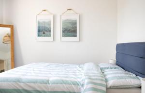 a bedroom with a bed and two pictures on the wall at Creag Dubh in Camastianavaig