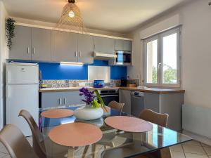 a kitchen with a table and chairs and blue cabinets at Bow View in Chartres