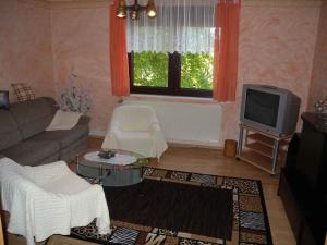 a living room with a couch and a tv at Apartment in Bergen auf Rügen 2835 in Bergen auf Rügen