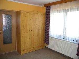 a room with a wooden cabinet and a window at Apartment in Bergen auf Rügen 2835 in Bergen auf Rügen