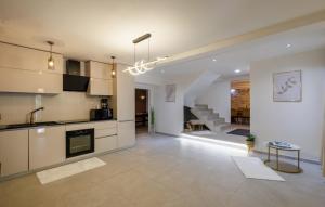 a kitchen and living room with a sink and a table at Villa Marina Neretva by Villas Guide in Metković
