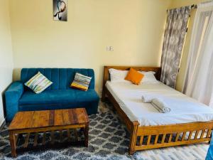 Postel nebo postele na pokoji v ubytování Brima Mangu Apartments, Bamburi Studio