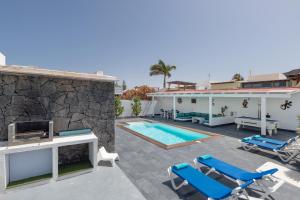 a villa with a swimming pool and a house at Villa Lunamoon, Playa Blanca in Playa Blanca