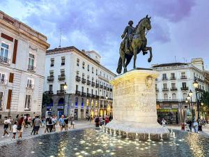 a statue of a man riding a horse in a city at La Casita de Loren in Madrid +12 photos