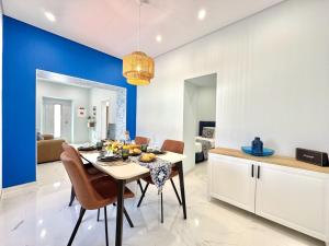 a kitchen and dining room with a table and chairs at Almancil Typical House by Homing in Almancil
