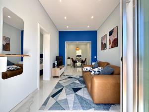 a living room with blue walls and a brown couch at Almancil Typical House by Homing in Almancil