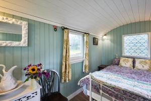 a bedroom with a bed and a window at Host & Stay - Shepherd's Hut in Briston
