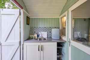 a small kitchen with a sink and a counter at Host & Stay - Shepherd's Hut in Briston