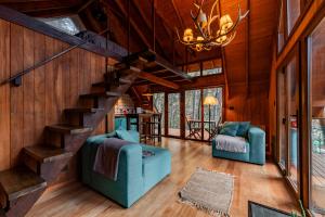 a living room with a staircase in a house at Complejo de Cabañas Ideales para parejas in San Carlos de Bariloche