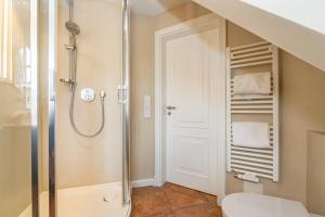 a bathroom with a shower and a toilet at Strandpirat in Wenningstedt +16 photos