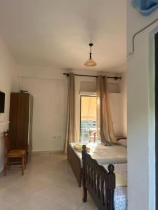 a bedroom with a bed and a large window at Moliana Bunec in Himare +28 photos