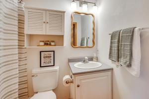 a bathroom with a toilet and a sink and a mirror at 3 Mi to Gunstock Mountain Resort Gilford Getaway in Gilford +33 photos