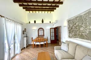 a living room with a couch and a table at Villa Viola Bosch Menorca in Cala'n Bosch