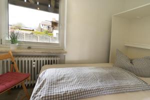 a bedroom with a bed and a window at Sophie -203- in Mittenwald