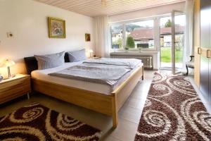 a bedroom with a bed and a large window at Sophie -203- in Mittenwald