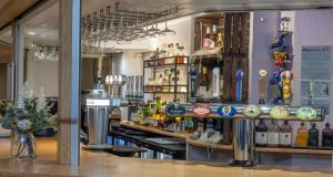 a bar in a restaurant with a lot of alcohol at Best Western Weymouth Hotel Rembrandt in Weymouth +73 photos