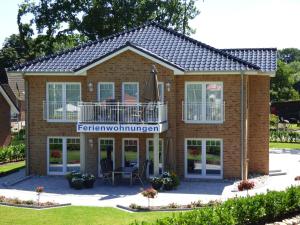 a house with a balcony and a patio at Villa Kanalblick, Ausguck in Oldenbüttel +35 photos