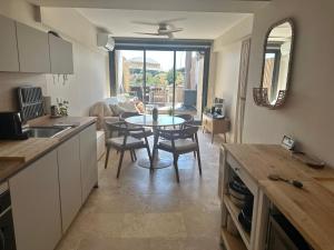 a kitchen and dining room with a table and chairs at Appartement à Collioure pour familles avec piscine et parking - FR-1-309-529 in Collioure +11 photos