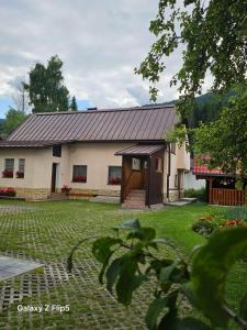 a large white house with a large yard at Privát Marika in Terchová
