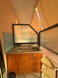 a kitchen with a sink in a tiny house at Moliana Bunec in Himare