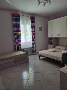 a bedroom with two beds and a couch and windows at Casa Nadiia in Cinisi +29 photos
