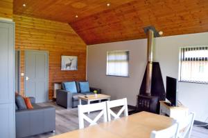 a living room with a couch and a table at Willow Plus 2 in Garton