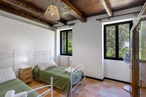 a hospital room with two beds and windows at Villa Franca Nature Holidays in Rezzo