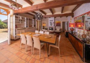 a kitchen and dining room with a wooden table and chairs at Jardin sur Loire in Blois