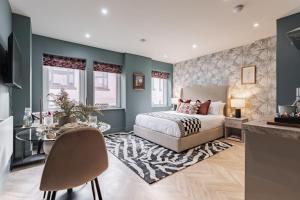 a bedroom with a bed and a table at Athena Suites Leeds LS1 Free Secure Parking! in Leeds