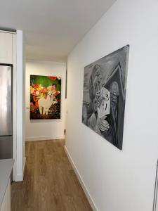 un corridoio con due dipinti su un muro di Beach Front House in Los Lances a Tarifa