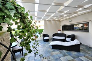 a living room with two chairs and a couch at Hotel Life in Rimini