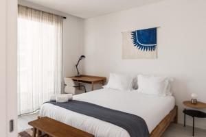 a bedroom with a white bed and a window at Outsite Private Villa with Infinity Pool and Ocean View in Ericeira +14 photos